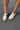 Image show's top view of models feet; model is wearing the Wingin It Ivory Snake Mule Loafers