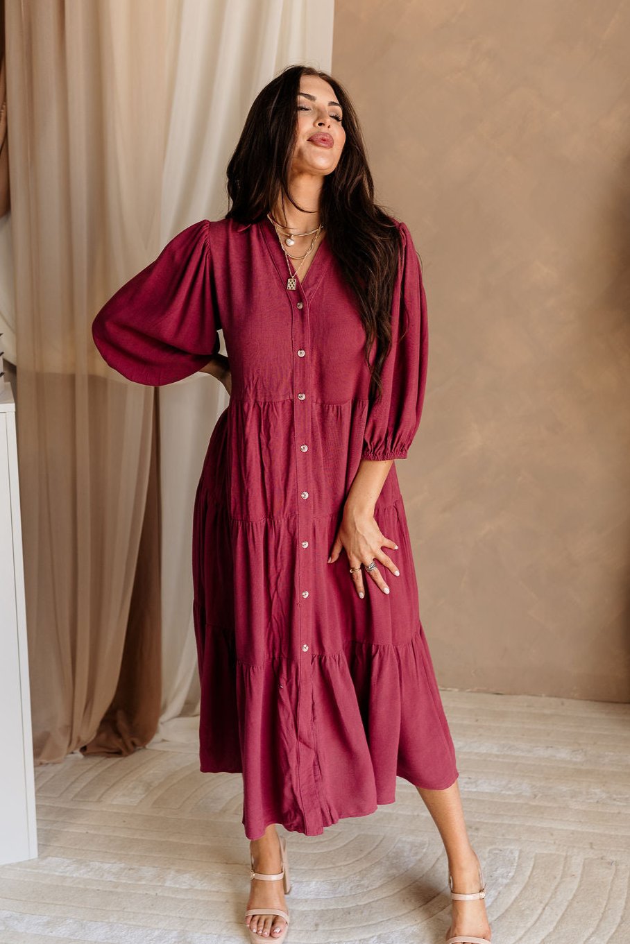 Full body front view of female model wearing the Penny Button Up 3/4 Sleeve Midi Dress in Berry that has a button up front, 3/4 sleeves, and a collar.