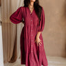 Full body front view of female model wearing the Penny Button Up 3/4 Sleeve Midi Dress in Berry that has a button up front, 3/4 sleeves, and a collar.