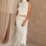 Full body front view of female model wearing the Hillary Ivory Fringe Midi Skirt, paired with matching top.