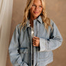 Front view of female model wearing the Samantha Zip Up Denim Jacket unzipped.