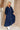 Full body frontal/side view of female model wearing the Penny Button Up 3/4 Sleeve Midi Dress in Navy that has a button up front, 3/4 sleeves, and a collar.