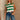 Front view of female model wearing tStacia Green & White Striped Sweater Tank, worn with jeans.