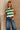 Front view of female model wearing tStacia Green & White Striped Sweater Tank, worn with jeans.