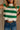 Close frontview of female model wearing tStacia Green & White Striped Sweater Tank, worn with jeans.