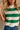 Close front view of female model wearing tStacia Green & White Striped Sweater Tank, worn with jeans.