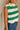 Close side view of female model wearing tStacia Green & White Striped Sweater Tank, worn with jeans.