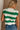 Back view of female model wearing tStacia Green & White Striped Sweater Tank, worn with jeans.