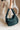 Image shows model holding the Olivia Puffer Tote in Green