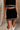 Front view of female model wearing the Remi Black & White Mini Skirt, paired with matching top.