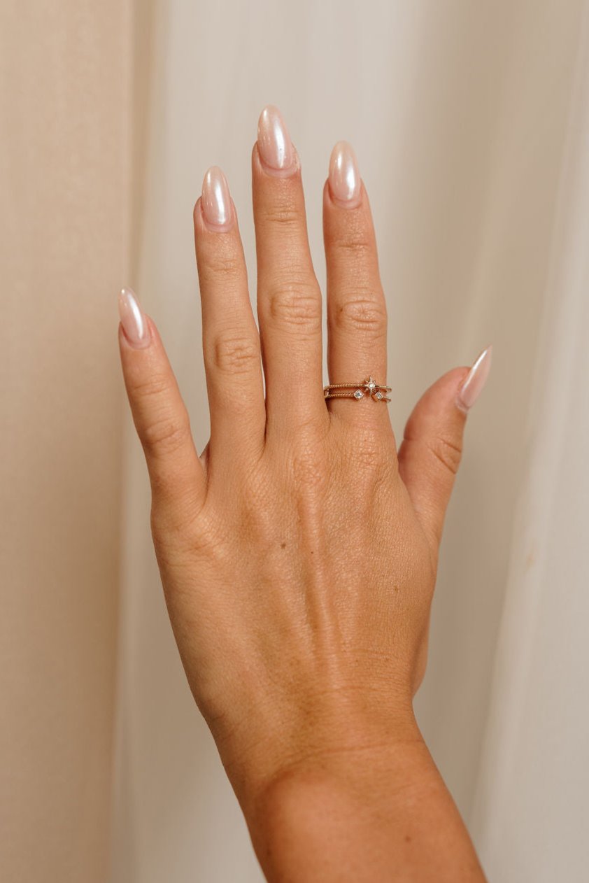 Image shows the Melina Gold & Rhinestone Ring on a female model hand.