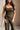 Close front view of female model wearing the Britney Olive Wide Leg Jumpsuit.