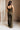 Full body back view of female model wearing the Britney Olive Wide Leg Jumpsuit.