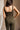 Upper body back view of female model wearing the Britney Olive Wide Leg Jumpsuit.