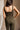 Upper body back view of female model wearing the Britney Olive Wide Leg Jumpsuit.