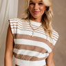 Upper body front view of female model wearing the Kiera White & Mocha Striped Top, paired with matching skirt.