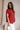 Model is shown wearing the Hazel Blouse in red. 