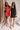 Full body front view of two female models. Once is wearing the Peyton Denim Zip Front Mini Dress in black and one in red.