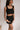 Front view of female model wearing the Giselle Black Shorts with matching top.