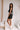 Full body side view of female model wearing the Giselle Black Shorts with matching top.