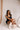 Model is pictured wearing the Tianna Romper in a size small.