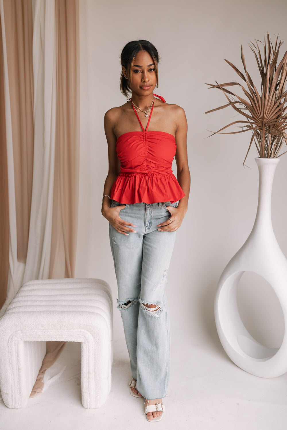 Model is pictured wearing the Georgia Halter Top in a size small.