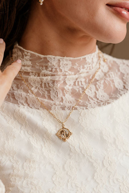 Cleo Gold Cross Pendant Necklace - close up view on model