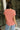 Upper body back view of female model wearing the Sheridan Tee in the color Rust