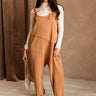 Full body front view of female model wearing the Arwen Sleeveless Jumpsuit in the color Peanut