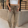 Lower body front view of female model wearing the Bethany Drawstring Cargo Pants in olive