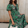 Front view of female model wearing the Vivica Green Floral Midi Dress.