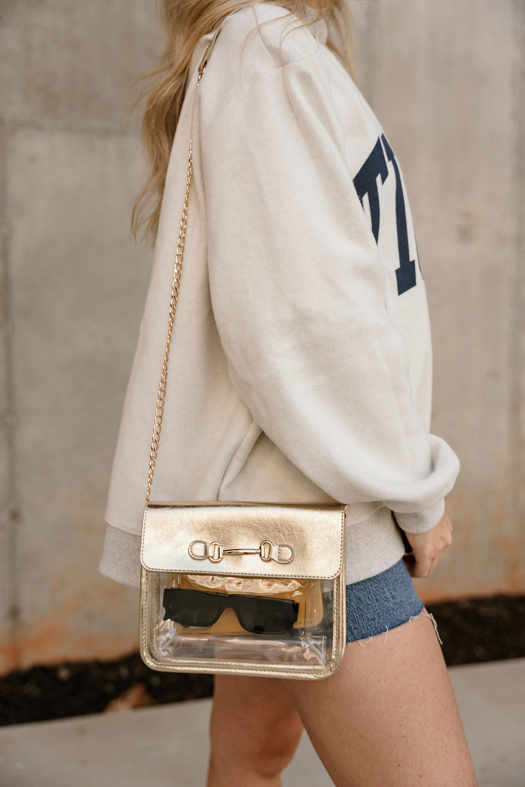 Rowan Clear & Gold Purse - front view on model