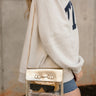 Rowan Clear & Gold Purse - front view on model