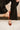 Rational Brown Patent Leather Pointed Toe Flats- shown with model on 1 foot