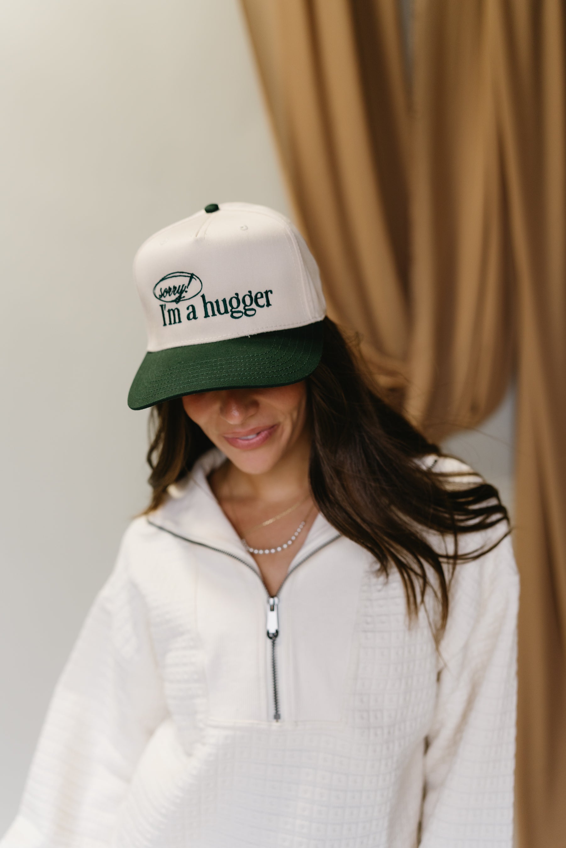 Sorry I'm A Hugger Green Trucker Hat - front view of hat on model