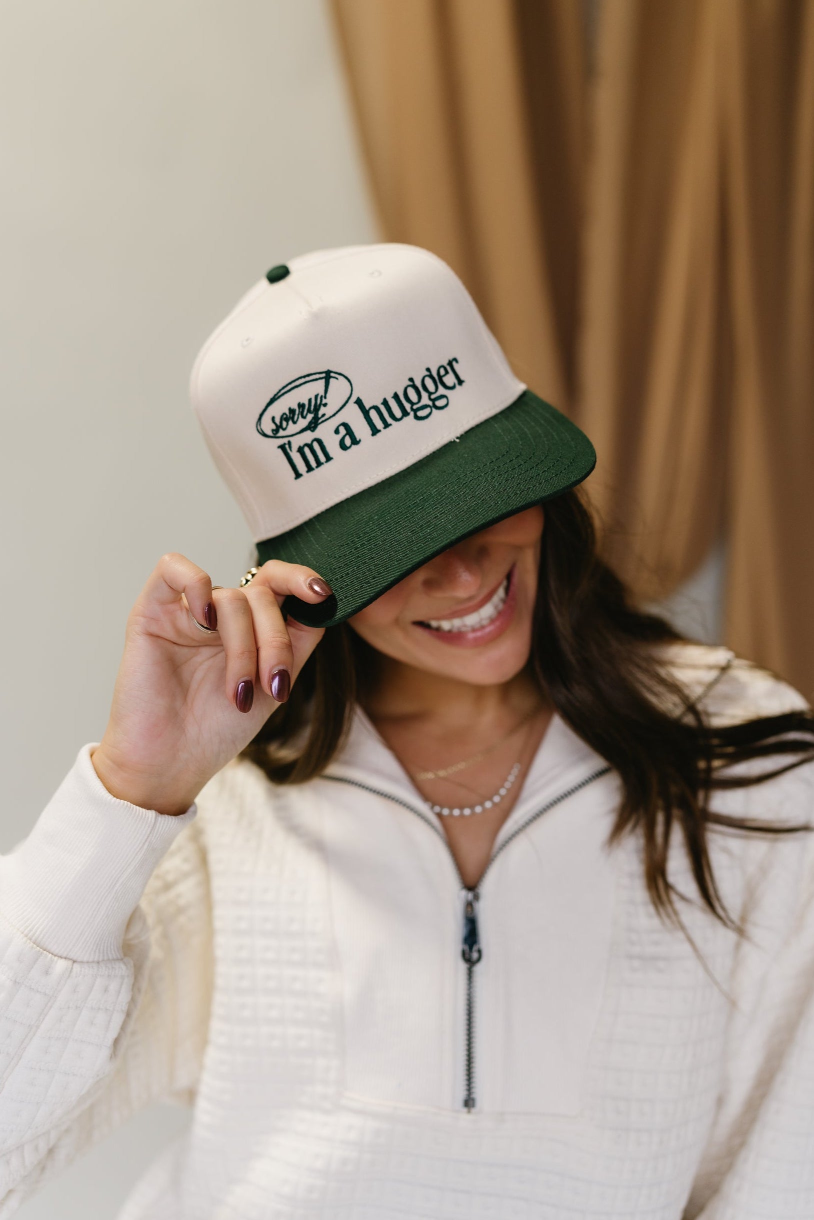 Sorry I'm A Hugger Green Trucker Hat - close front view of hat on model