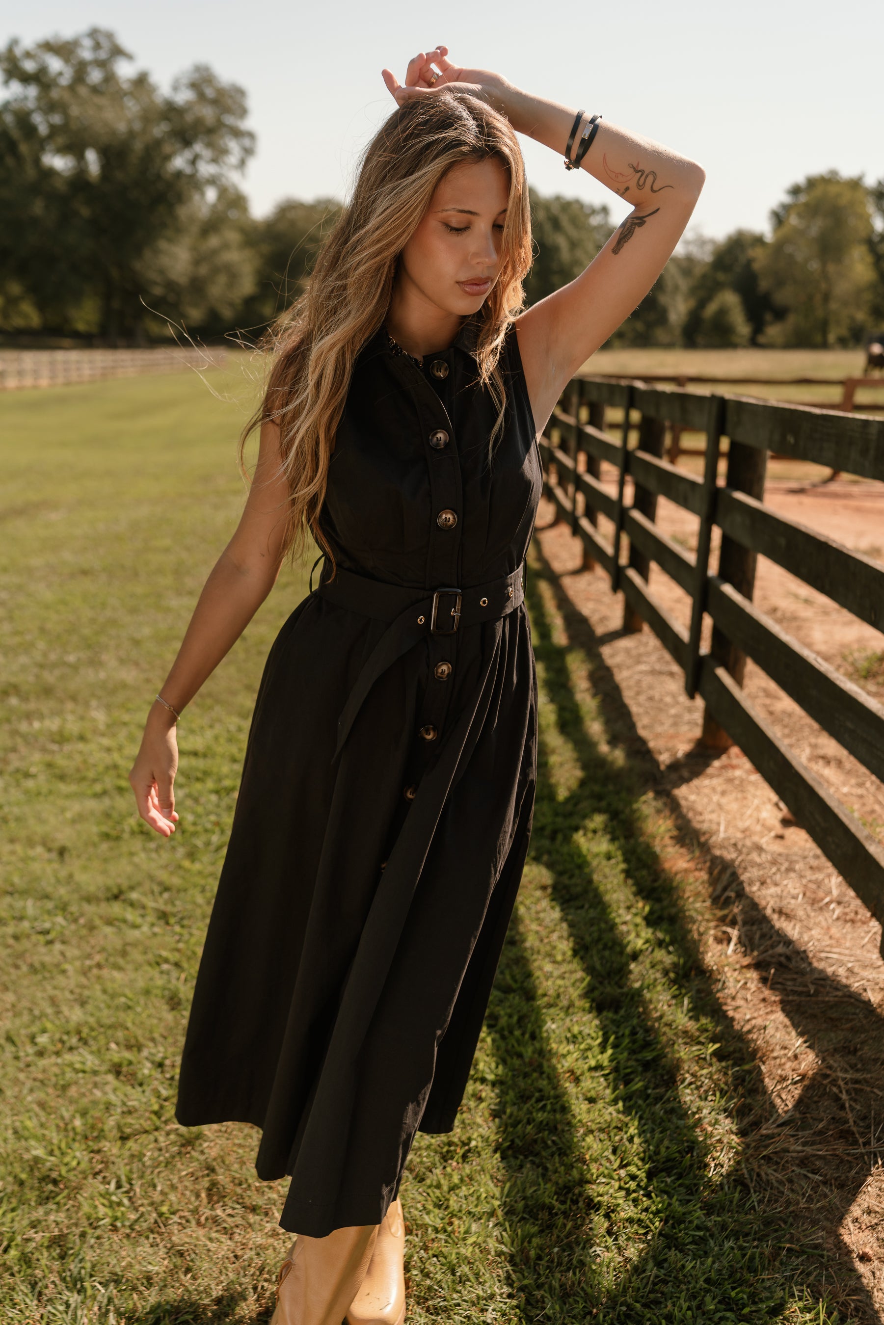front view of the Augusta Black Buckle Midi Dress