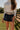 Corinne Dark Denim Mini Skort - close up front view (with belt)