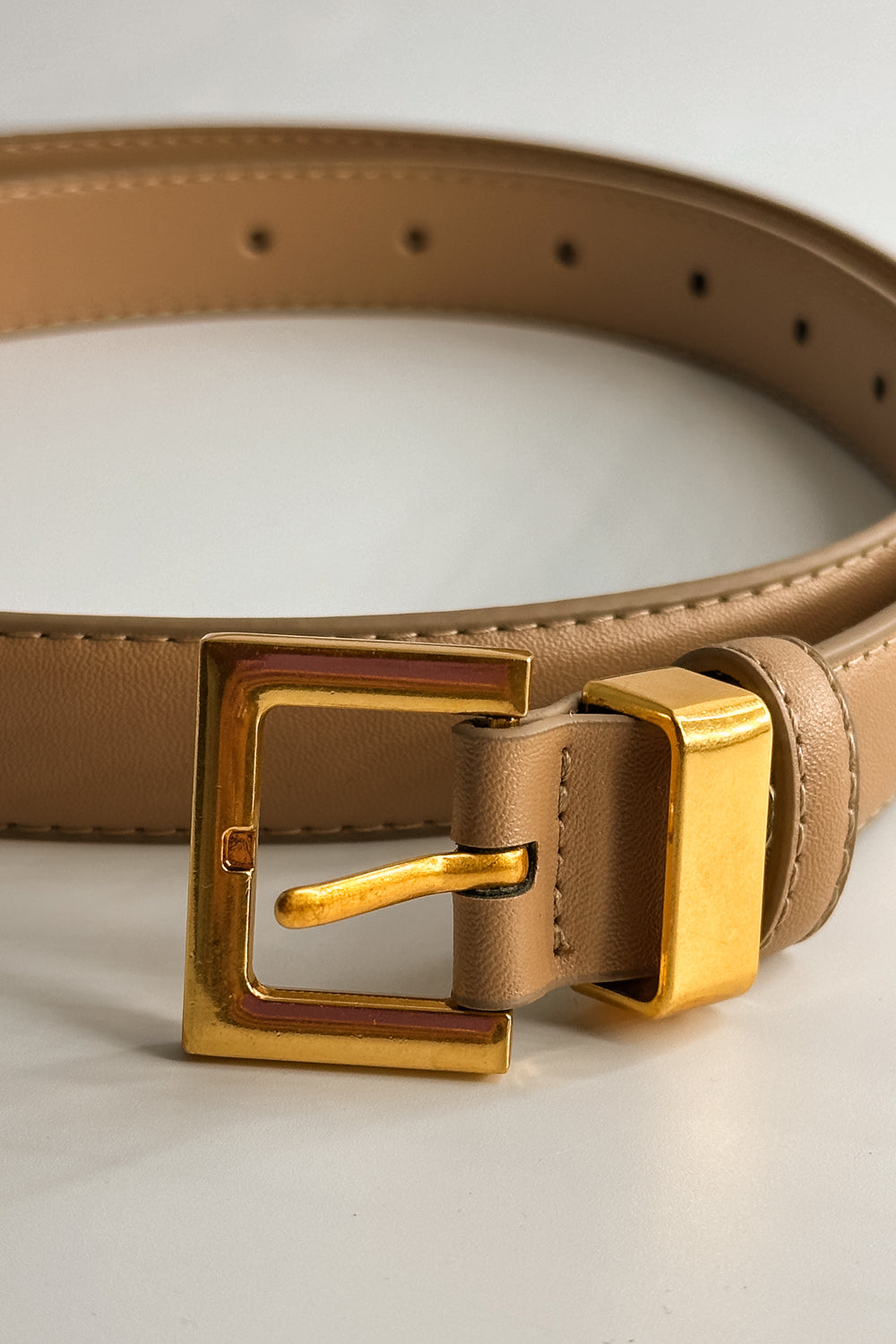 Front close up view of the Iris Taupe Slim Square Buckle Belt which features taupe Leather Fabric  and Gold Square Adjustable Buckle