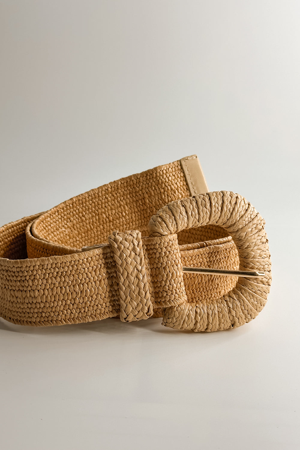 Front view of the Nova Light Tan Rattan Belt which features khaki rattan fabric, monochrome rattan covered adjustable buckle