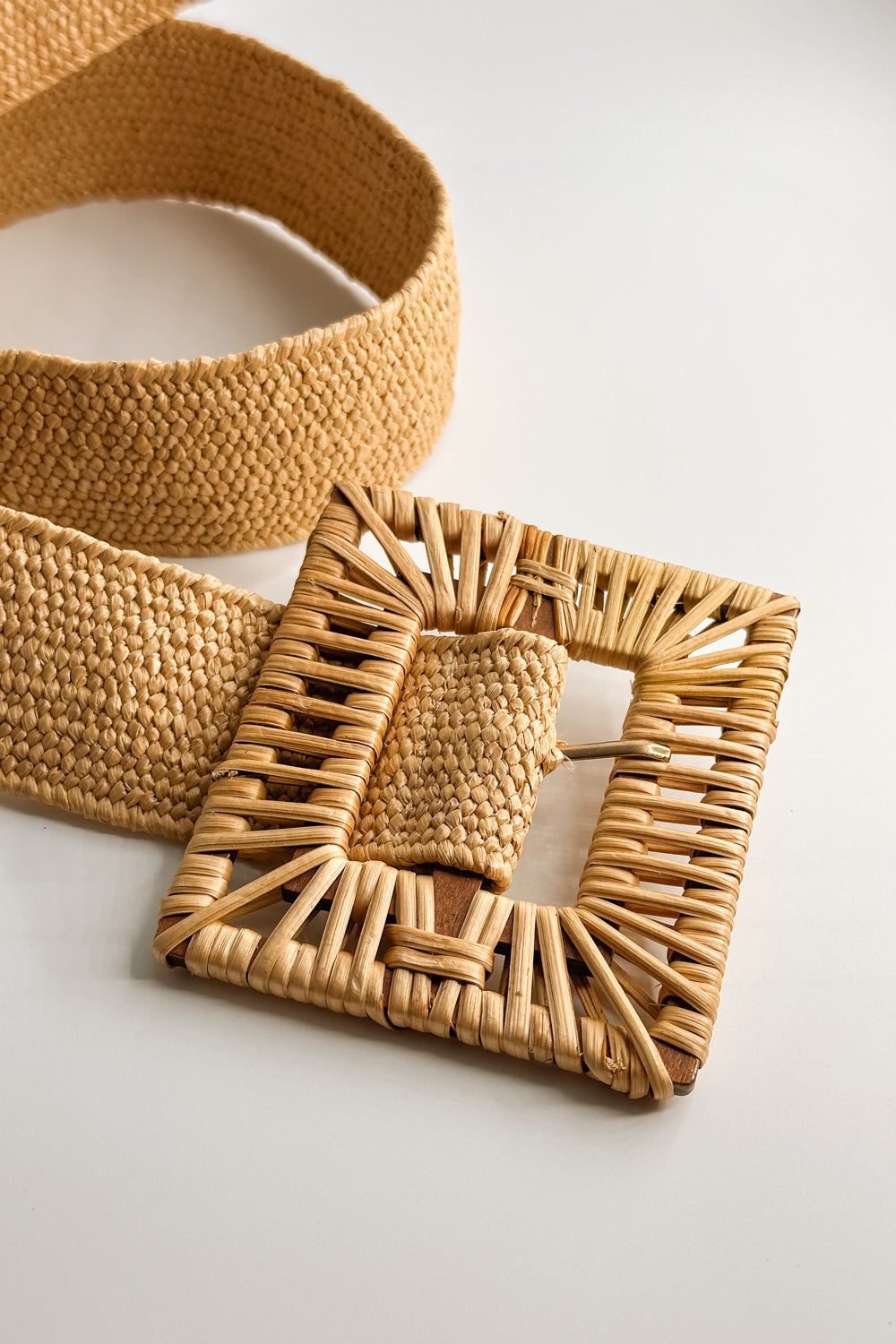 Close up view of the Savannah Tan Rattan Square Adjustable Belt which features tan rattan fabric, square rattan adjustable buckle