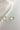 Flat lay view of the Mila Iridescent Scoop Teardrop Stud Earring which features iridescent teardrop studs