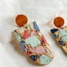 Close up view of the Wrenly Cork Multi Dangle Earring which features cork dangle earrings with multi color spots design