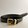 Front view of female model wearing the Ariana Black Slim Square Buckle Belt which features Black Leather Fabric and Gold Square Adjustable Buckle