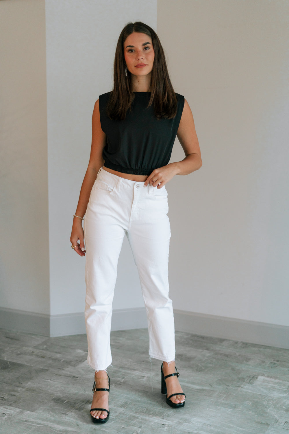 Full body view of female model wearing the Ayla White Straight Leg Jeans White Denim Fabric, Straight Leg, Two Front Pockets, Two Back Pockets, Front Zipper with Button Closure and Fray Hem