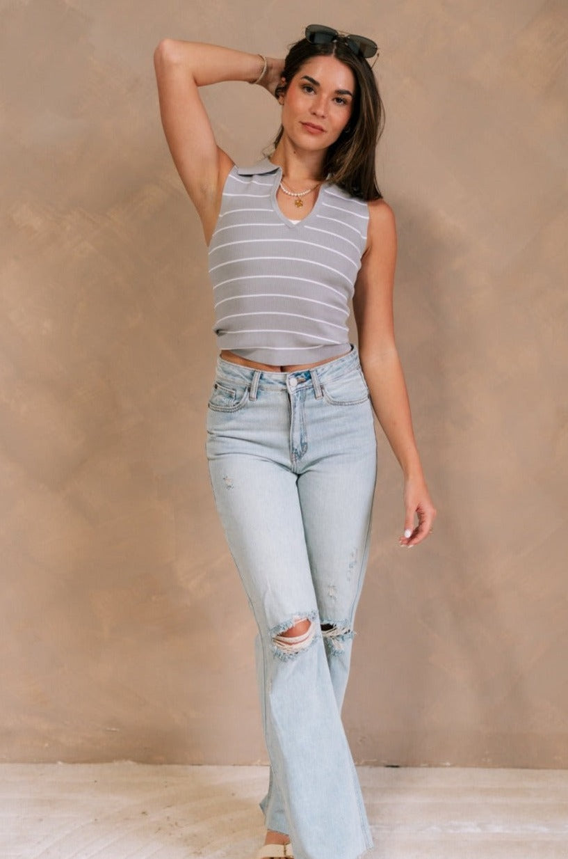Full body view of female model wearing the Cali Grey and White Stripe Sleeveless Tank which features Grey and White Knit Fabric, Stripe Pattern, Collared Neckline and Sleeveless