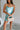 Front view of female model wearing the Dorit Light Blue Satin Mini Dress which features Light Blue Shimmer Fabric, Mini Length, Cowl Neckline and Skinny Straps