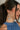 SIde view of female model wearing the Sienna White & Blue Pearl Dangle Earring which features  teardrop, dangle earrings with white pearls and blue design beads
