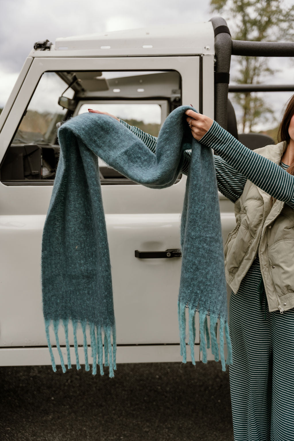 Leighton Blue & Teal Fringe Scarf - view of scarf being held by model