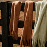 Marlowe Brown Fringe Scarf - close up on fence